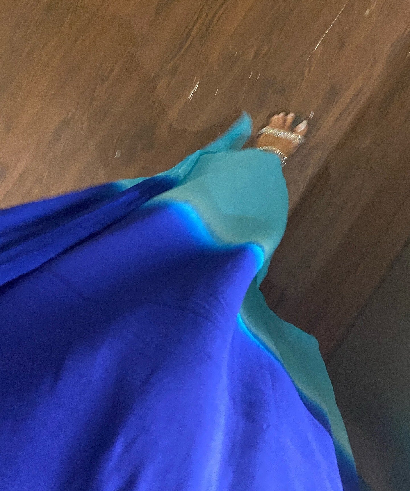 Close-up of a blue fabric on a wooden floor